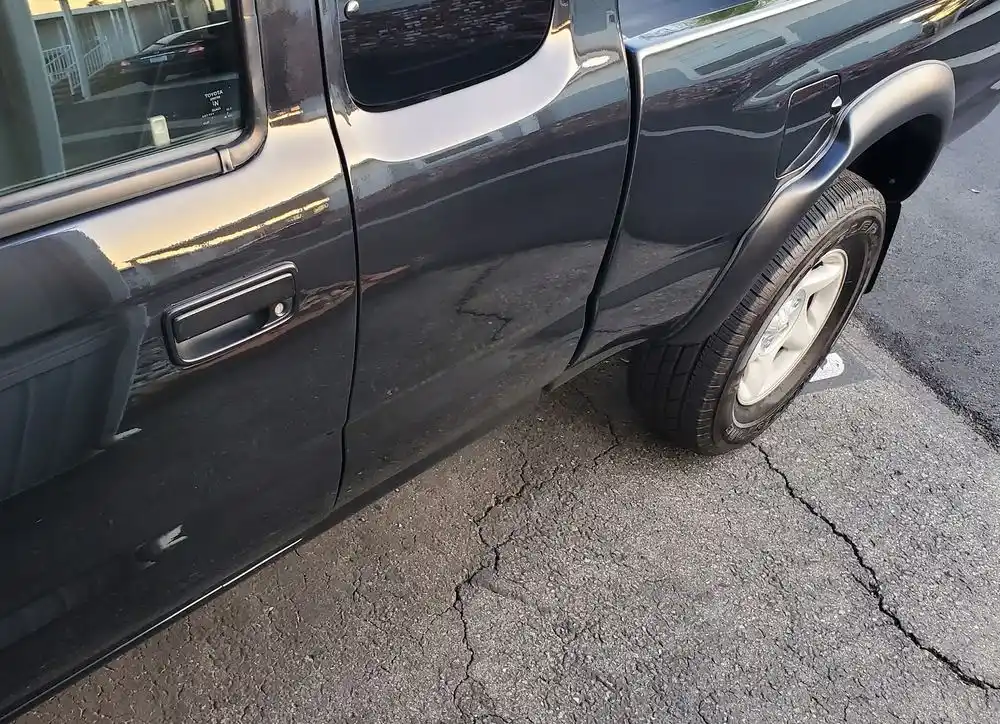 The same pickup doors and bed side after collision repair and paint refinishing